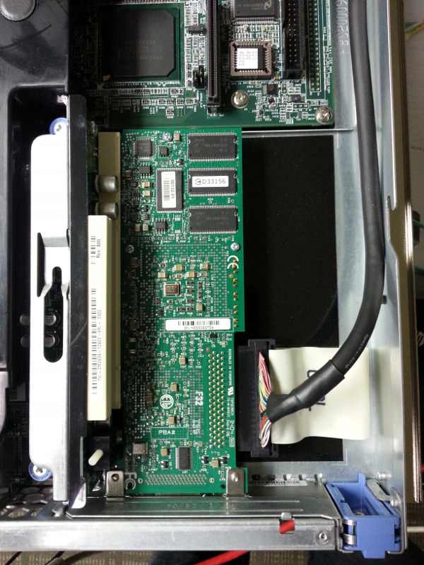 The SCSI RAID controller in the Dell PowerEdge 750 expansion bus. The plastic guard is in the bottom-right corner. The PCI riser screws are to the left of the expansion bus.